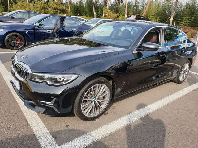 Front three-quarter view of a black 2021 BMW 330i
