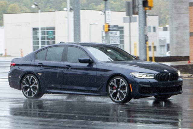 Front three-quarter view of a dark blue 2021 BMW 540i xDrive sedan