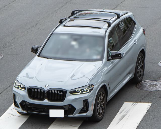 Overhead front three-quarter view of a Brooklyn Grey 2022 BMW X3 M40i with roof rails